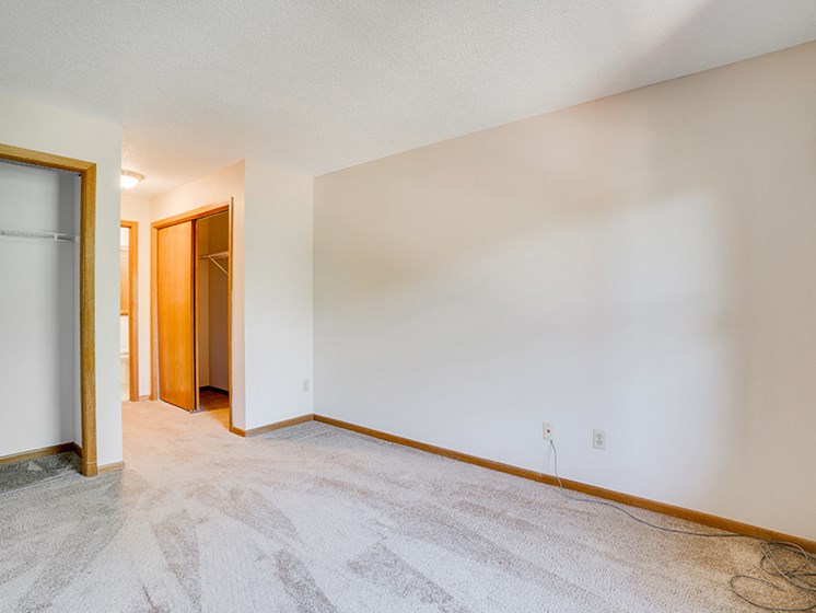 Empty bedroom with white carpet and walls